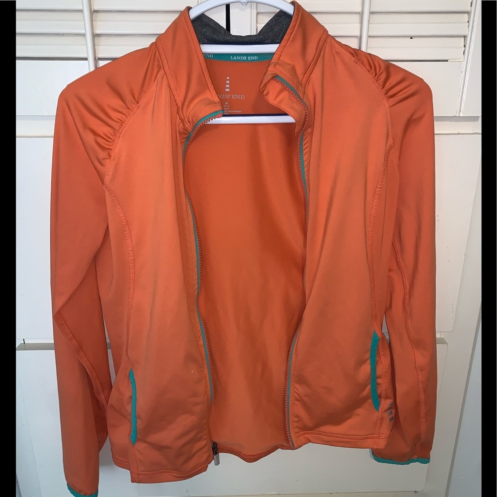 ORANGE ZIP UP JACKET WITH A LITTLE BLUE